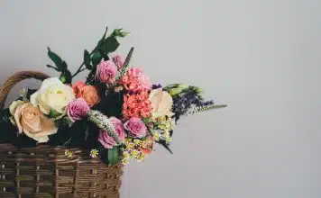 assorted-color flowers on brown wicker basket