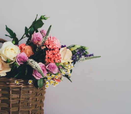 assorted-color flowers on brown wicker basket